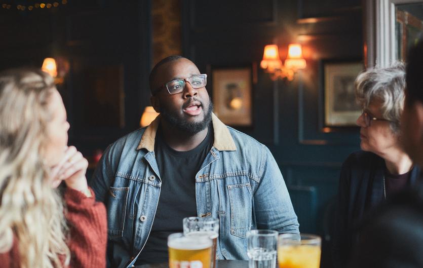 Everyday tips Man talking with friends in a pub