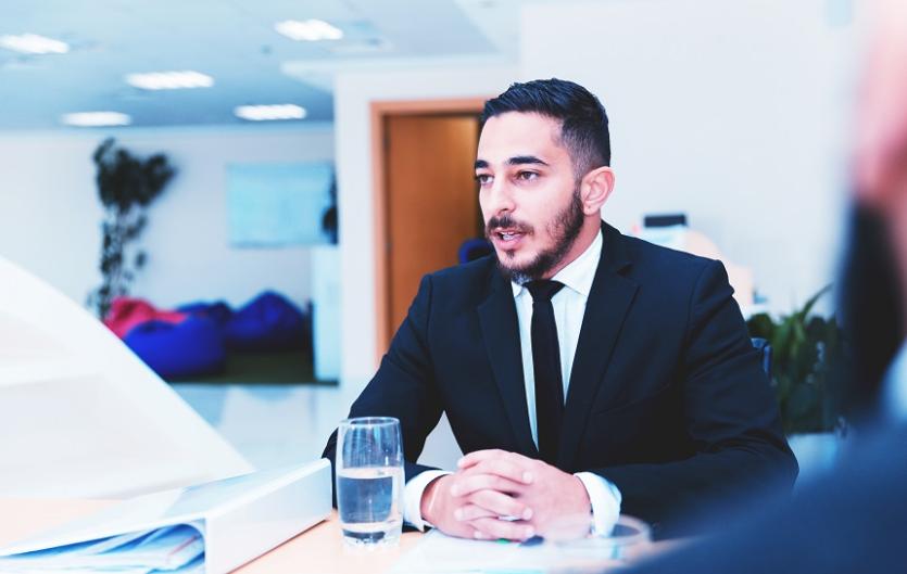 Recruiting Someone Who Stammers A man in a suit at a work meeting or interview