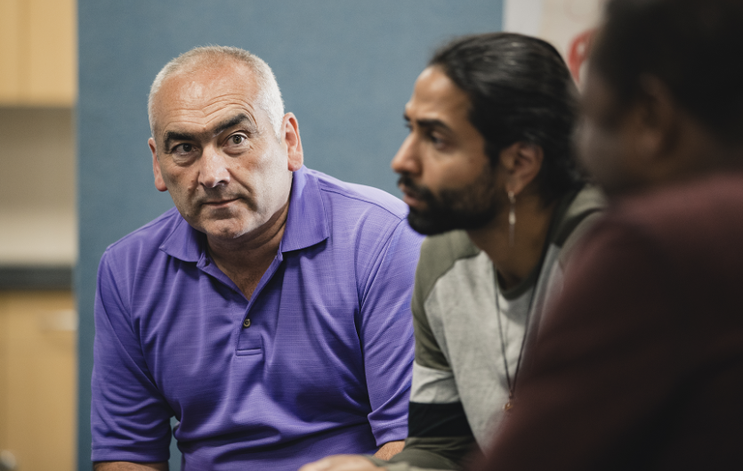 Therapy & Courses Two men sitting in a group setting