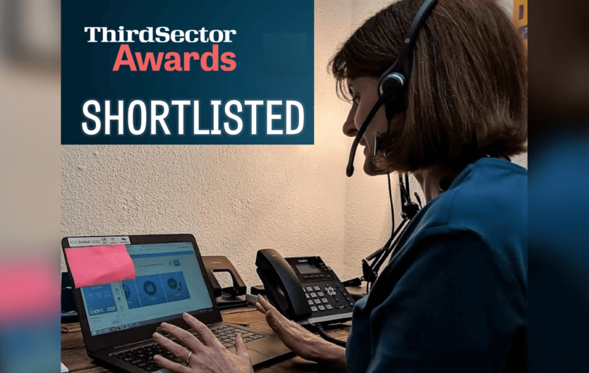Being shortlisted for Volunteer Team of the Year A woman in front of a computer wearing a headset