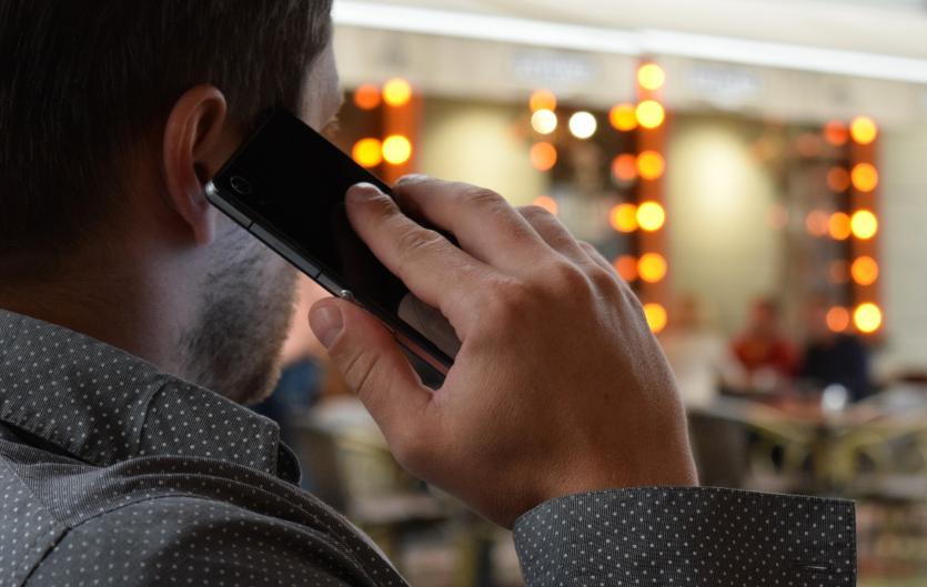 Worries over Voice Risk Analysis to combat crime A man speaking on the telephone, seen from behind