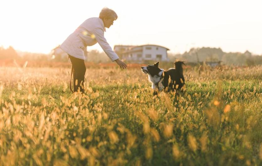It is possible to live free and succeed with a stammer A woman in the outdoors, playing with her dog