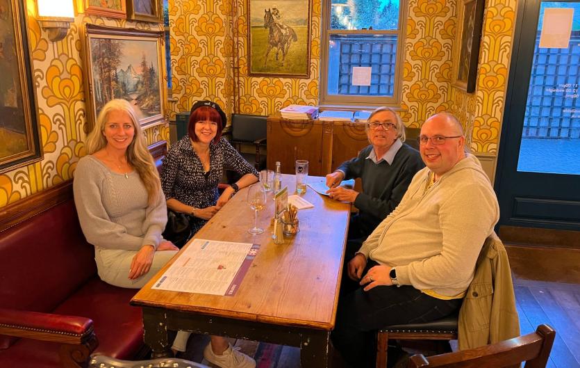 The Wokingham & Reading Stammering Group Four people sitting round a pub table looking at the camera and smiling