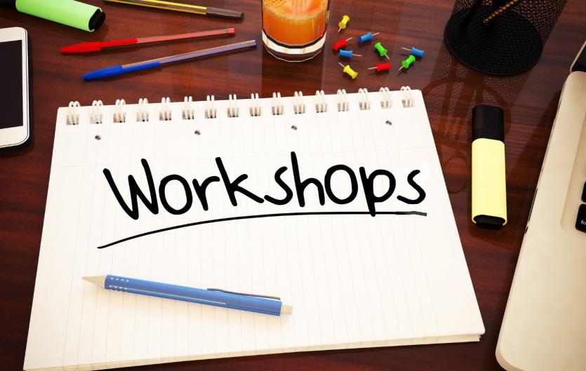 A notepad with a handwritten note across it reading 'Workshops'