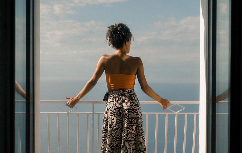 I've accepted my stammer is a part of me. It is what it is A woman on a balcony looking out to sea