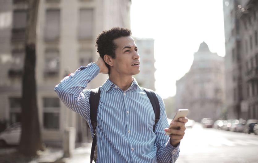 Stammering set me up for success A man in the street holding a mobile phone