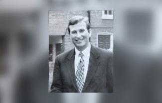 A man looking at the camera and smiling
