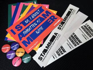 A selection of colourful postcards, stickers and badges