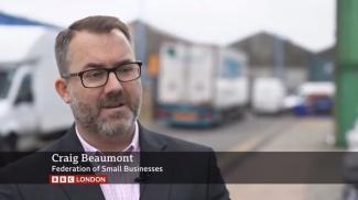 A man being interviewed with a caption below his name