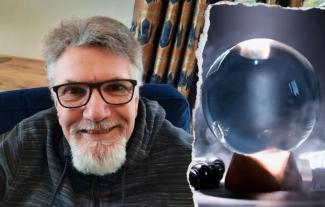 A man smiling for the camera, with an inset of a crystal ball