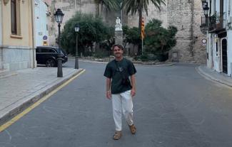 A man standing in the road in a Spanish town