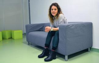 A woman sitting on a sofa and smiling