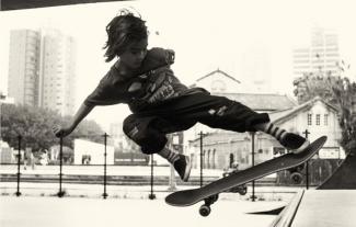 A boy skateboarding on a half pipe skateboard ramp