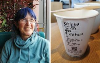 A woman smiling and looking to the right, and a takeaway cup with text on it