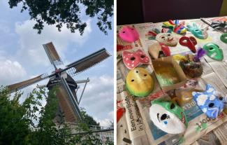 A windmill and a table with freshly-painted masks on it