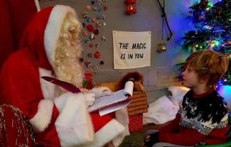 A young boy meeting Father Christmas