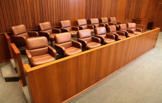 A juror's box with empty seats inside