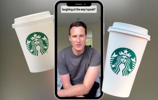 A smartphone displaying a man talking, with two takeaway coffee chain cups