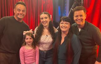 Three young people posing with TV presenters Ant & Dec