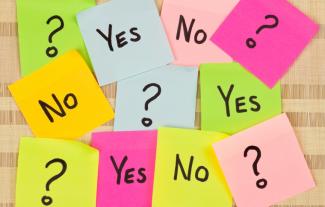 Eleven post it notes arranged randomly with 'Yes', 'No' and '?' written on them