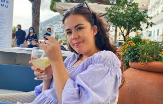 A woman drinking a cocktail in a holiday resort