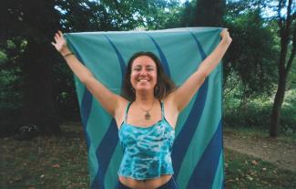 A woman holding a flag and smiling