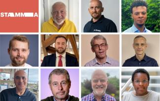 Eleven men and one woman smiling