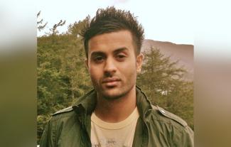 A man smiling in an outdoor setting