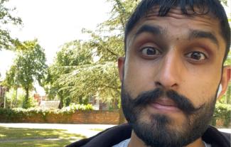 A close up of man's face in a park