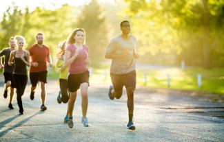 A group of people running in a park