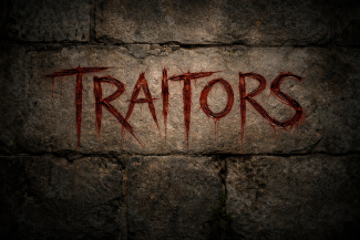 A stone wall with the words 'Traitors' scratched into it