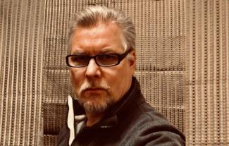 A man looking at the camera and looking serious