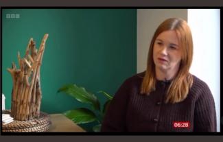 A woman being interviewed in her home
