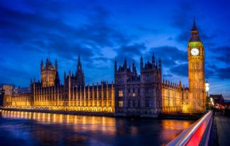 The Houses of Parliament against a cloudy sky at dusk
