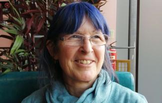 A women smiling and looking into the distance