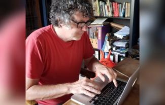 A man typing on a laptop keyboard