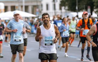 A man running a sponsored charity event, with other runners around him
