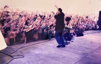 The singer Scatman John on stage performing to a crowd of people