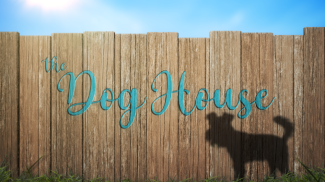 A wooden fence with the shadow of a dog on it, and handwriting that reads 'The Dog House'