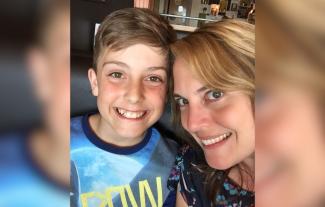 A mother and son, both smiling
