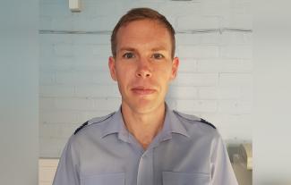 A man in a uniform looking at the camera