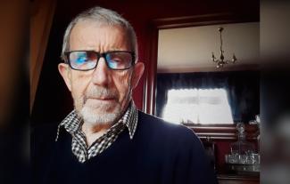 A man with a serious expression on his face