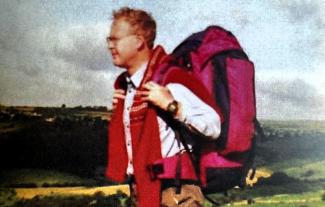 A man out on a hike, wearing a rucksack