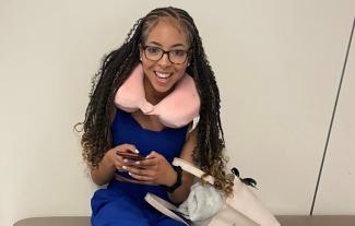 A woman holding a smartphone and smiling