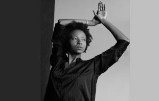 A woman with her arms in the air, looking to the side