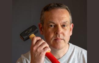 A man holding up a hammer