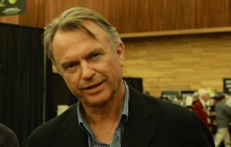 The actor Sam Neill smiling