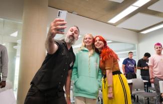 A man, woman and teenage girl taking a selfie