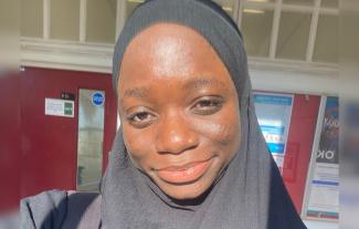 A woman in a headscarf, smiling