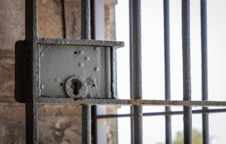 A lock on a prison barred door